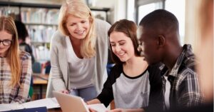 an educator assisting learners in a library