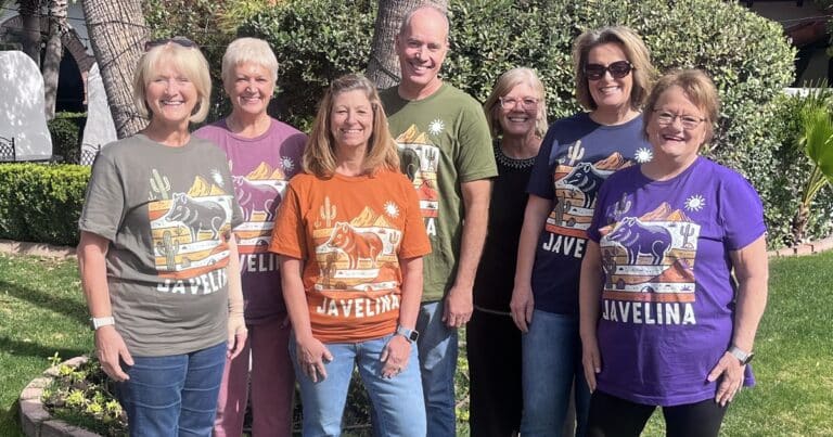 People pose for the camera in matching Javelina shirts